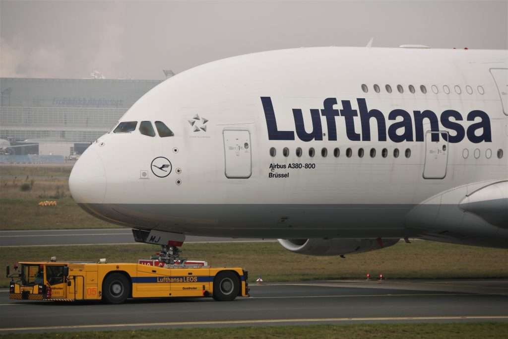 Hitching a ride, Lufthansa A380 "Brussel " getting a tow to remote parking in Frankfurt Airport.