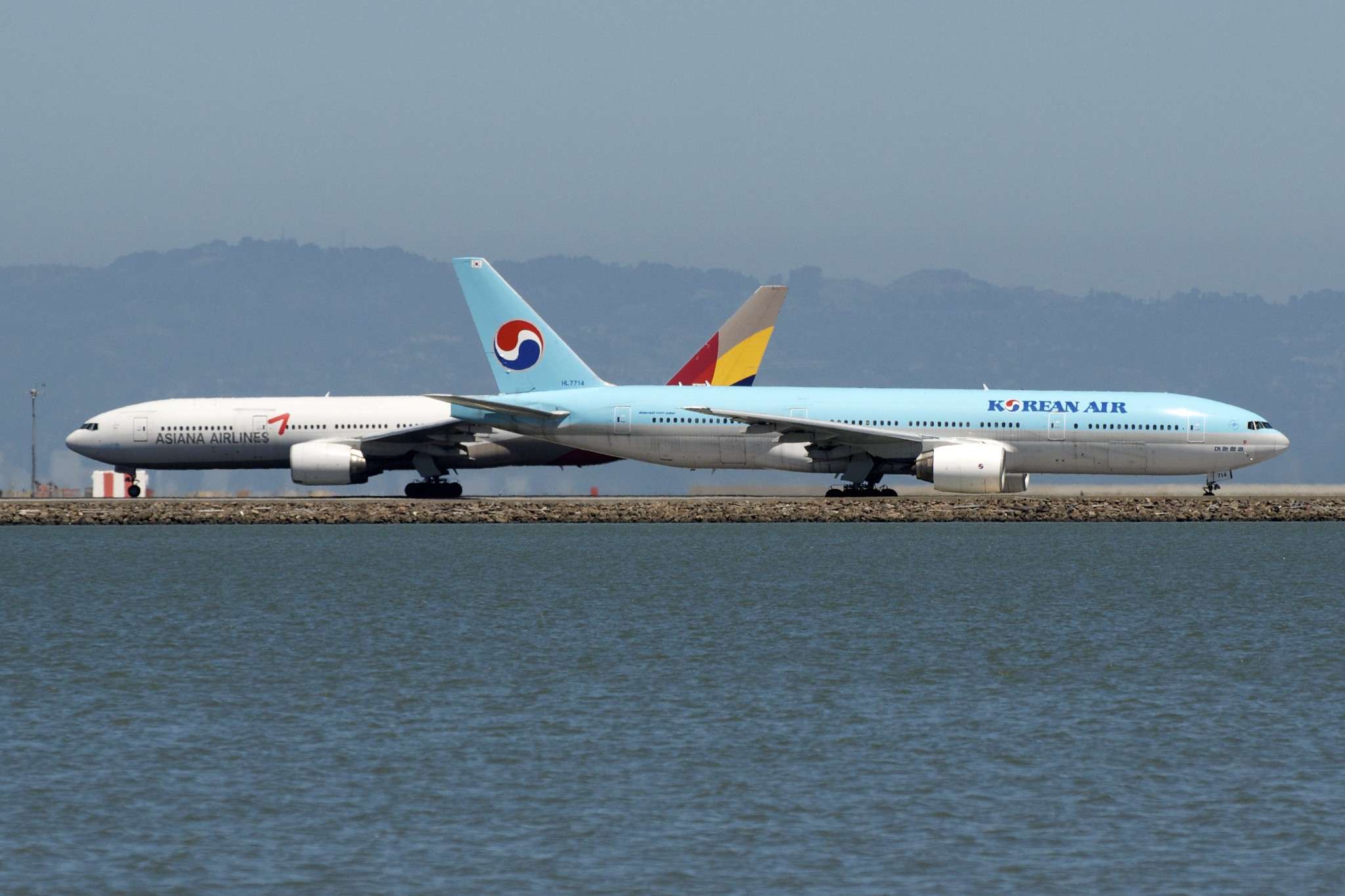 A Korean Air Boeing 777 with an Asiana Airlines Boeing 777