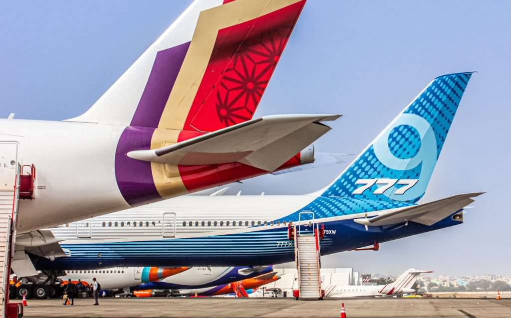An Air India Airbus A350 parked next to a Boeing 777X