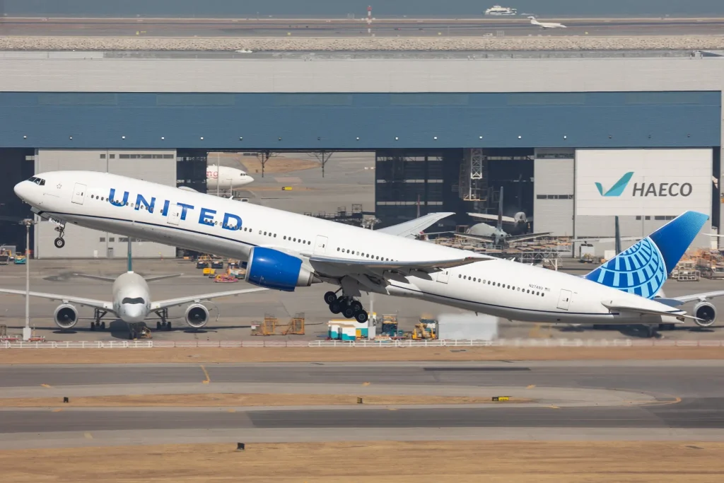 A United Airlines Boeing 777-300ER departs Hong Kong