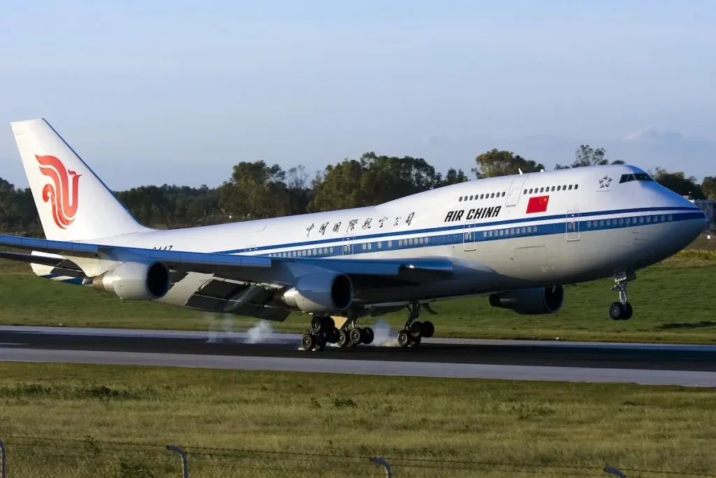 Air China Boeing 747-4J6 (REG: B-2447) landing runway 31 in the morning sun.