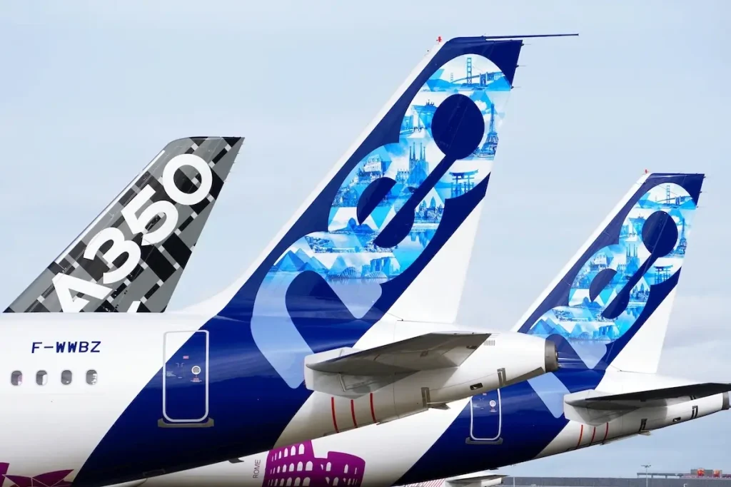 the tails of Airbus's experimental flight test vehicles, including A321XLRs and an A350, lined up at the flight test center in Toulouse