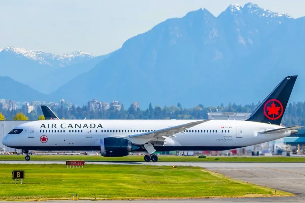 VANCOUVER, CANADA - May 11, 2019: Air Canada Boeing 787-9 on takeoff roll at Vancouver Intl. Airport with mountains in the background.