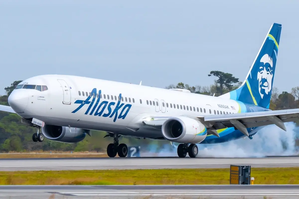 Charleston, SC - Nov 2, 2022: Alaska Airlines Boeing 737 landing on a runway with smoke from tires.