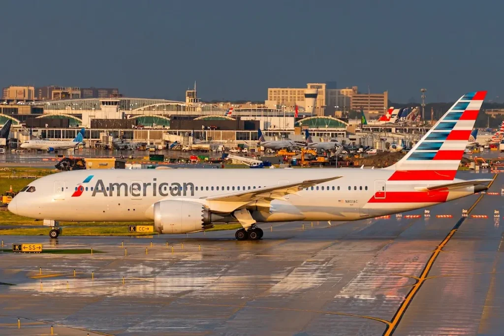 Chicago, Illinois USA - June 19 2024: American Airlines 787 at a wet Chicago O'Hare International Airport with the terminals in the background