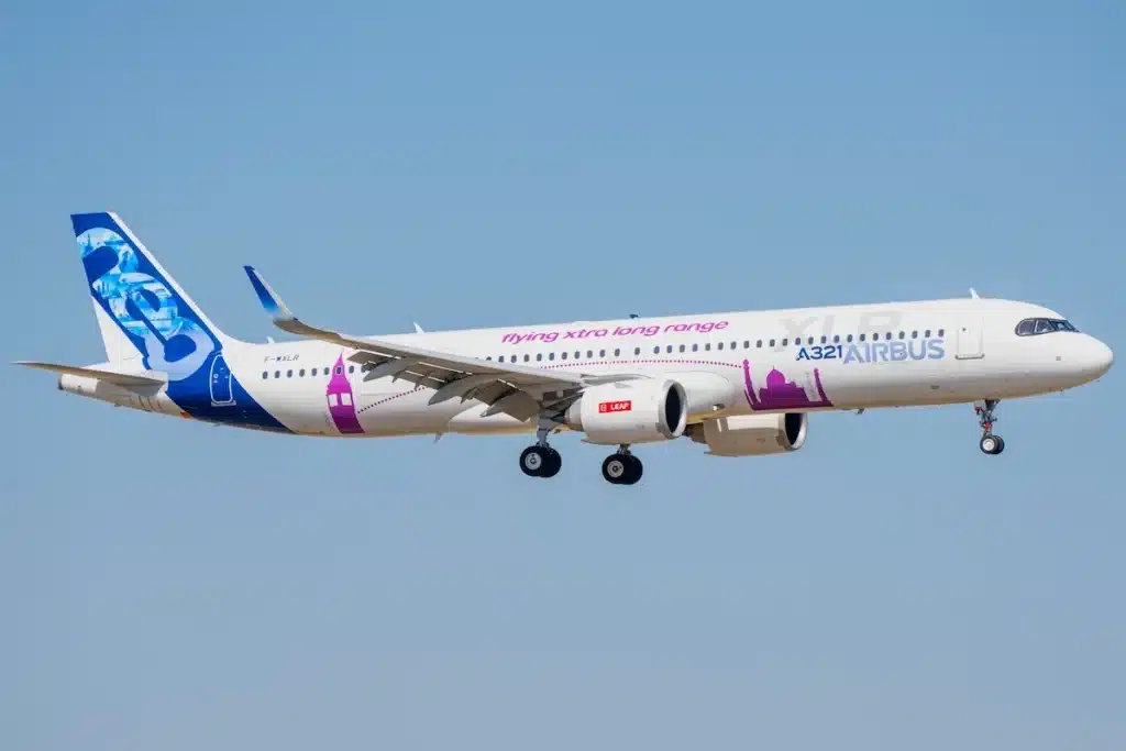 Moron, Spain - 3 May 23: An airbus a321xlr aircraft in flight, showcasing its sleek design and colorful livery against a clear blue sky