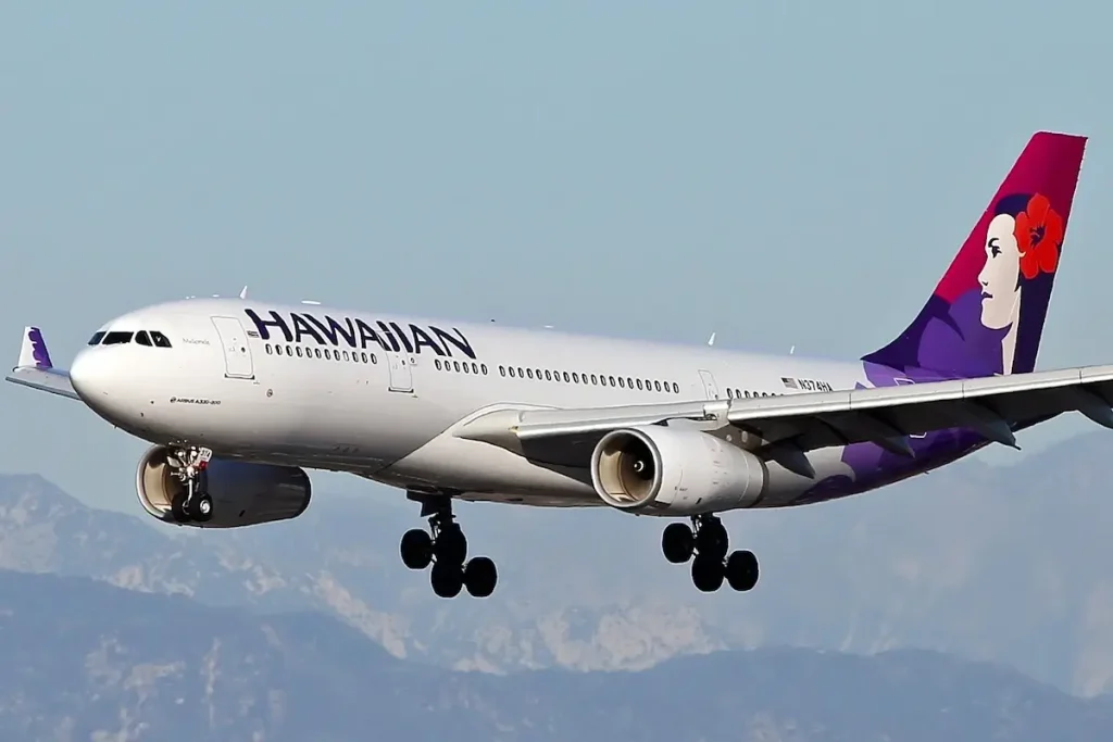 Los Angeles, California, USA - November 7, 2015: Hawaiian Airlines Airbus A330-243 approaching Los Angeles International Airport (LAX) with downtown Los Angeles in the background
