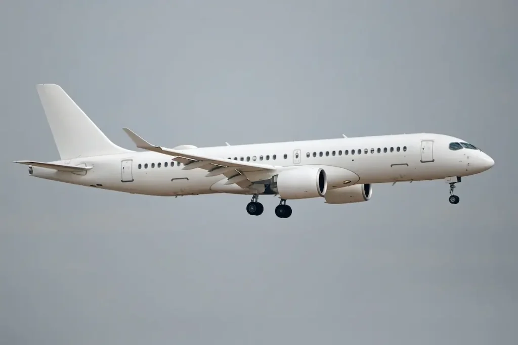 a White Airbus A220-300 aircraft preparing to land