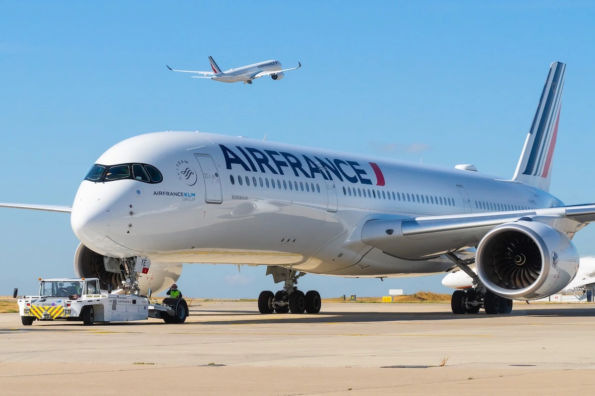 Air France Airbus A350 on pushback while another A350 is taking off in the sky September 07, 2020, Roissy en France, France