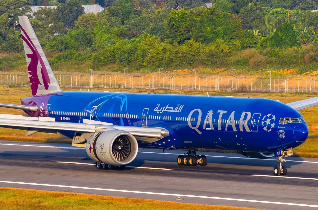 Phuket, Thailand – December 3, 2025: Qatar Airways Boeing 777 passenger aircraft in UEFA Champions League themed livery rolling on the runway after landing at Phuket International Airport.