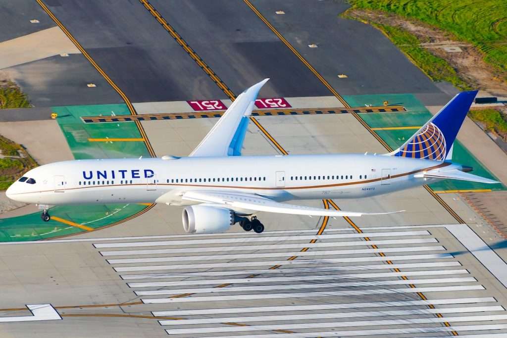 Los Angeles, CA / USA - February 15 2020: United Airline Boeing 787 Dreamliner on final approach LAX International Airport. Aerial view of 787-9 aircraft registered as N24973 over runway threshold.