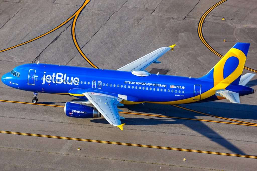 Orlando, United States - October 17, 2024: Aerial view photo of JetBlue Airbus A320 airplane with JetBlue Honours our Veterans special livery at Orlando Airport, United States.
