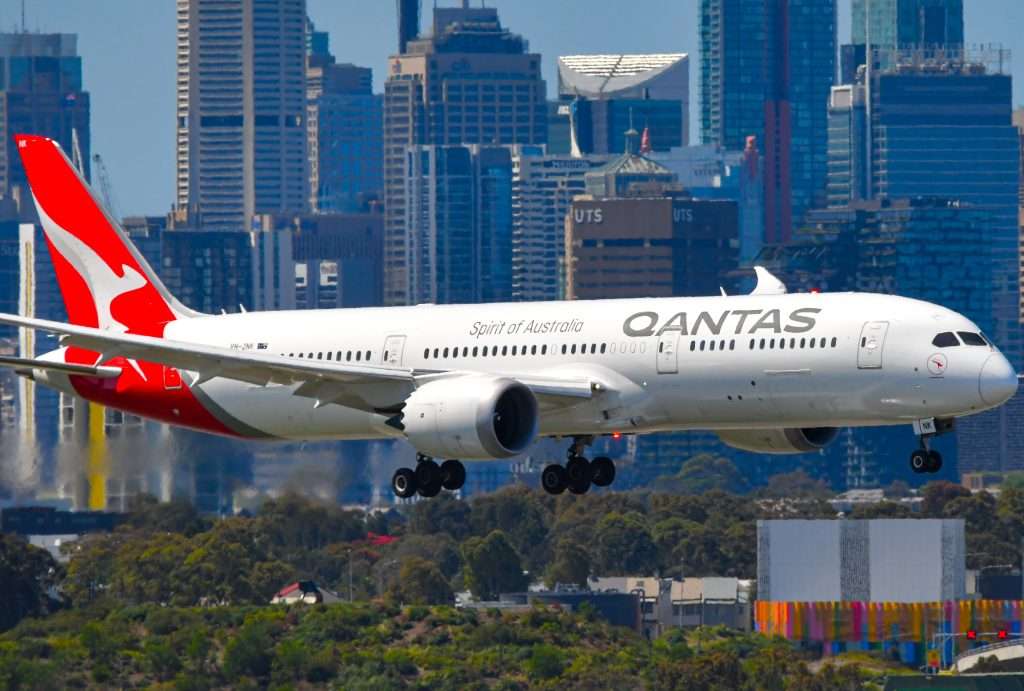 Sydney, NSW, Australia – October 25, 2022: Qantas Boeing 787-9 Dreamliner approaching Sydney Airport with city skyline in background