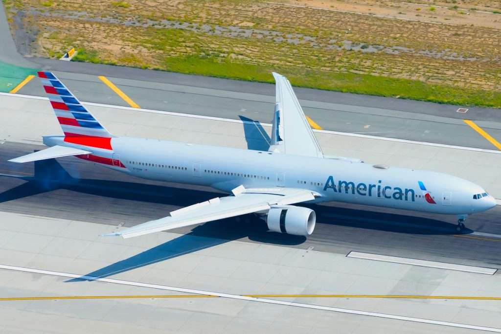 Los Angeles, CA / USA - May 30 2016: American Airlines Boeing 777 landing at LAX International Airport runway with slats and engine reverse thrust deployed. 77W aircraft registered as N725AN