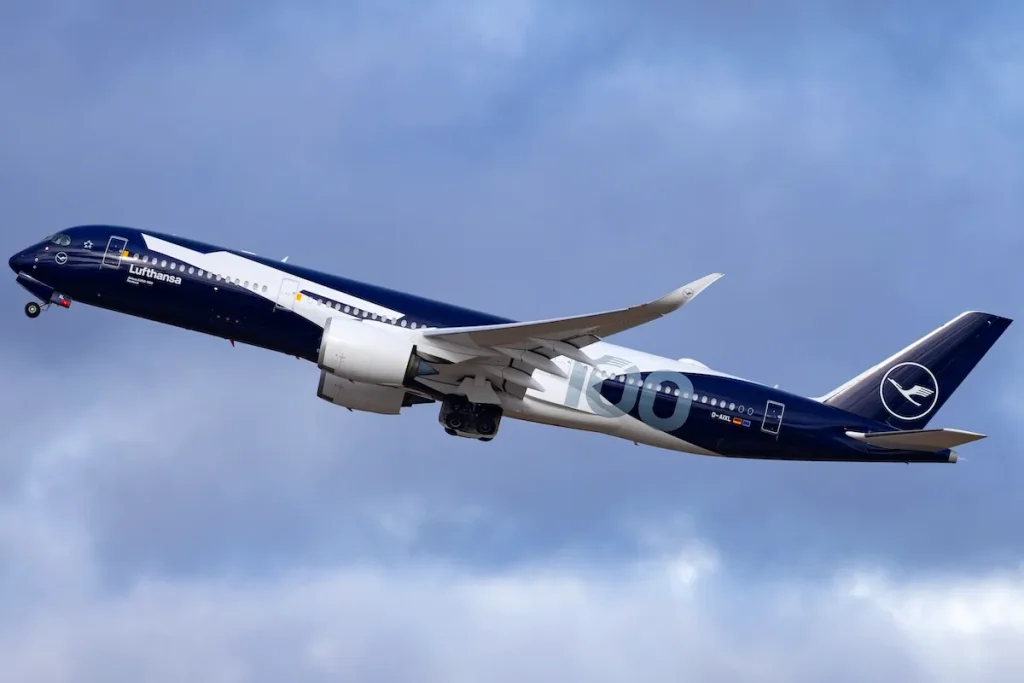 Lufthansa Airbus A350-900 passenger aircraft reg. D-AIXL named "Rostock" and wearing special "100th Anniversary" color scheme departing from runway 26