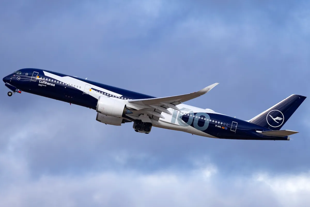 Lufthansa Airbus A350-900 passenger aircraft reg. D-AIXL named "Rostock" and wearing special "100th Anniversary" color scheme departing from runway 26