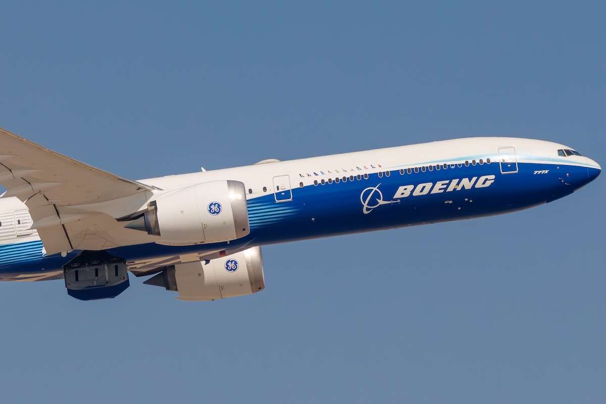 Boeing 777X widebody aircraft captured in clean side profile during a flight demonstration at Dubai Airshow 2025 in the UAE