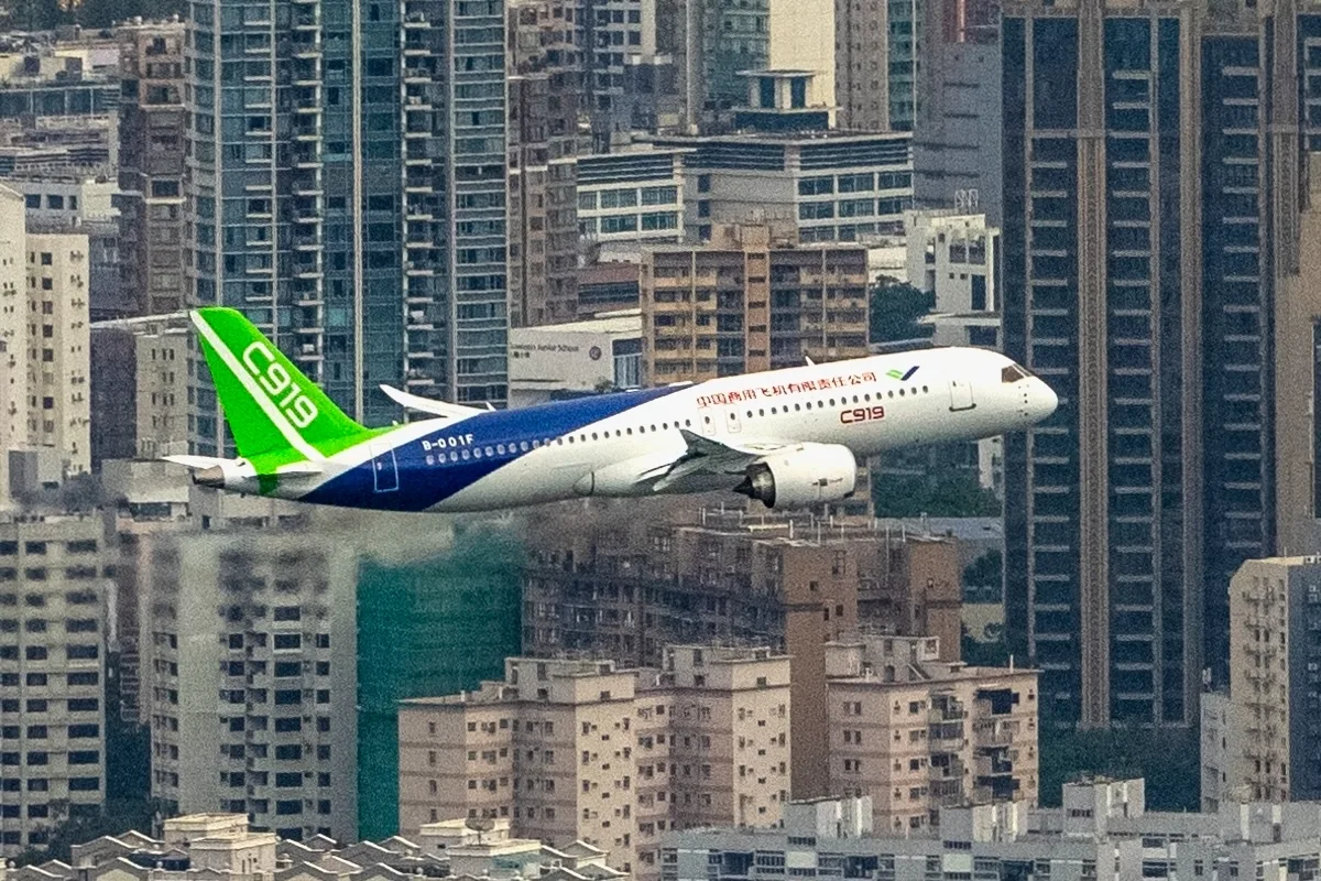 C919 aircraft, one of the new passenger jets made in China, conducts a flight demonstration over Victoria Harbour. The C919 visits Hong Kong for the first time