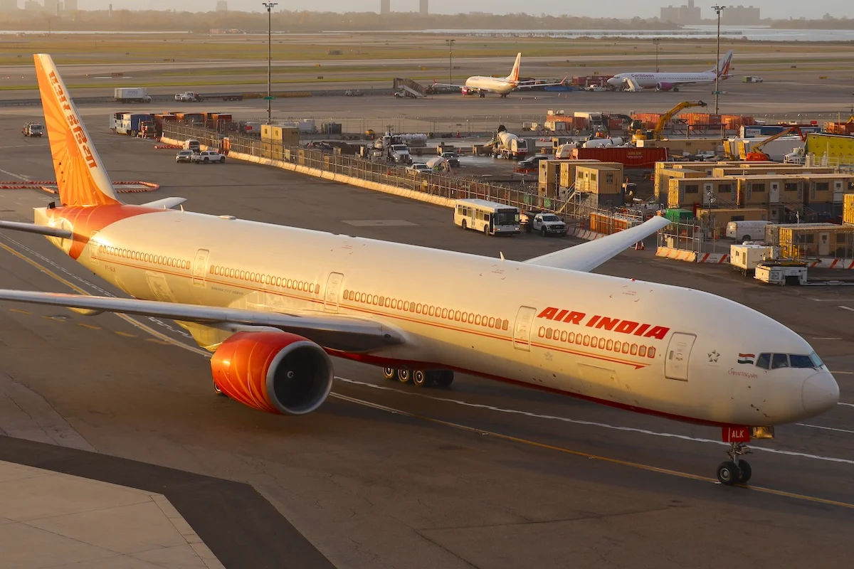 Air India 777-300ER with tail number VT-ALK landing at JFK Airport on a hazy morning