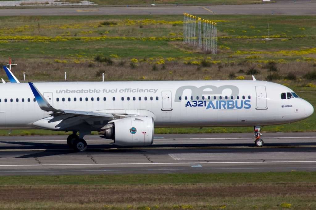 New passenger aircraft Airbus A321neo takes off from the airport runway.