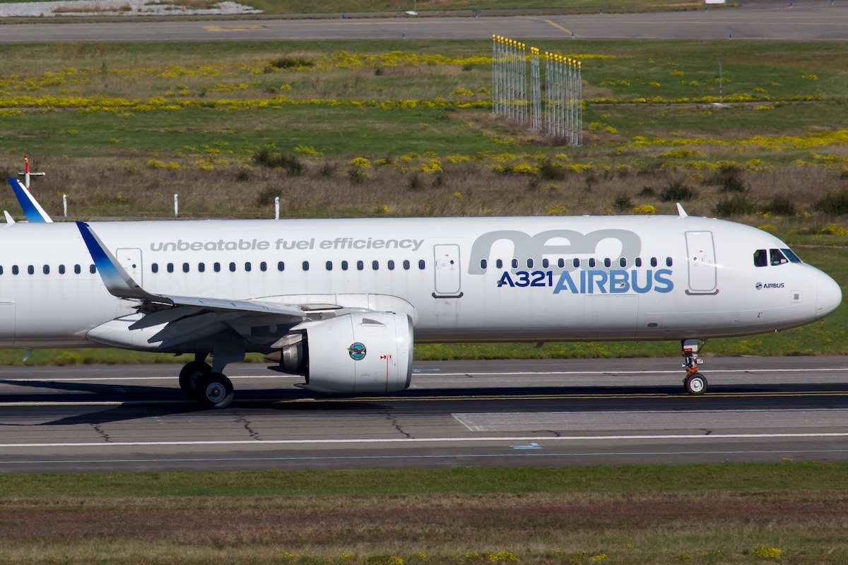New passenger aircraft Airbus A321neo takes off from the airport runway.