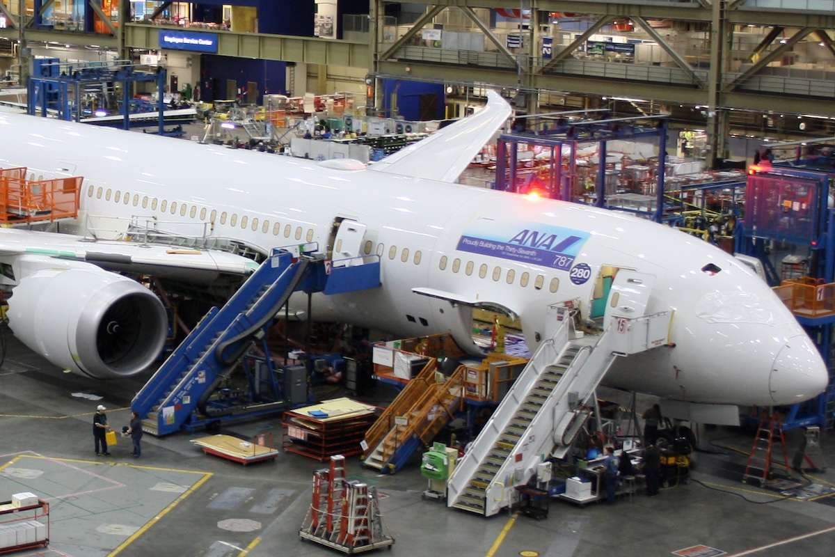 Unidentified Boeing employees continue work building a Boeing 787 jets at its Everett factory, including for Japanese airline All Nippon Airways (ANA)